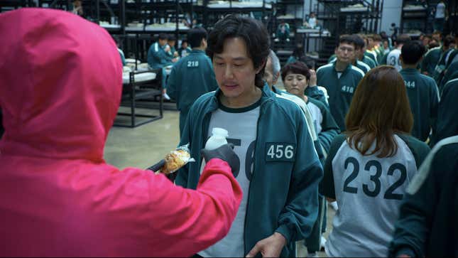Gi-hun handed bun and milk, Squid Game