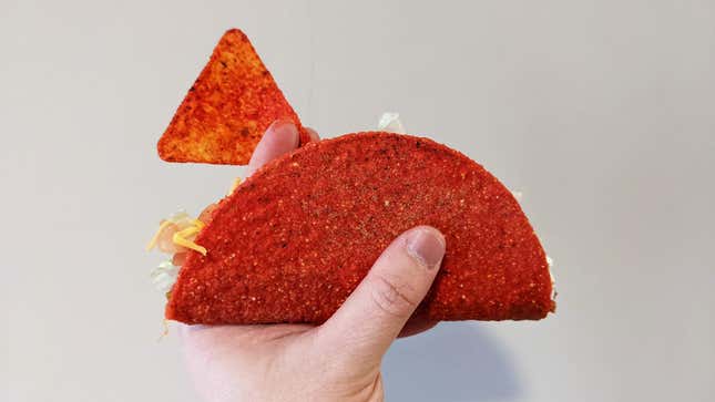 hand holding doritos locos taco and dorito