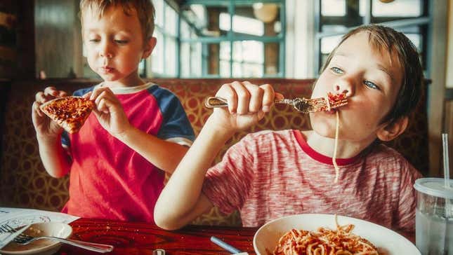 Kids eating food at restaurant