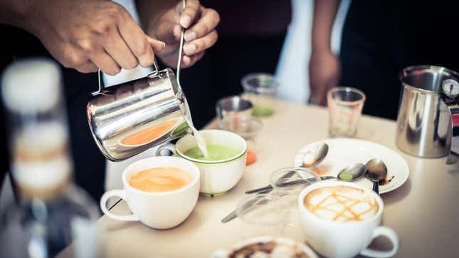 Barista pouring lattes