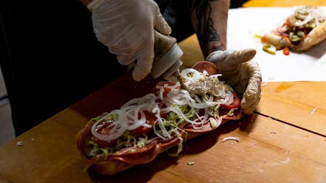 Vinaigrette being dispensed on a hoagie
