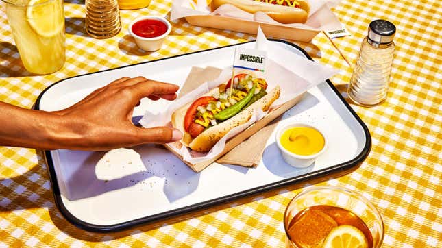 hand reaching for chicago-style hot dog