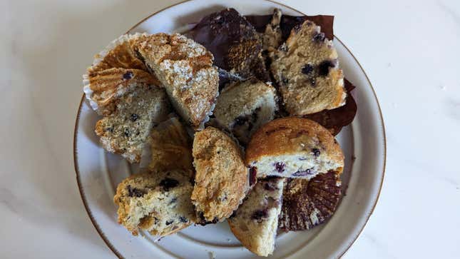 Dunkin, Starbucks, McDonald's, and Panera blueberry muffins all sliced on a plate