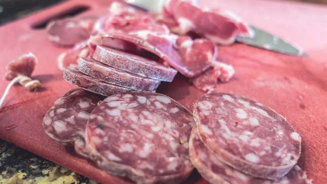 Sliced hard salami on cutting board