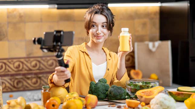 woman vlogging with juice