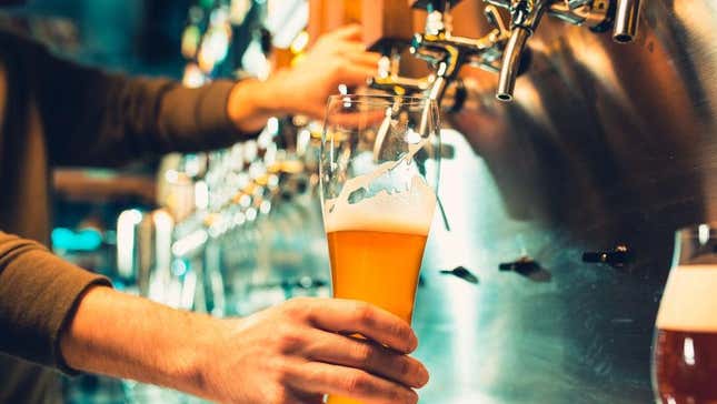 Pouring draft beer from tap in bar