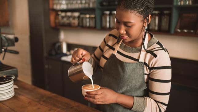 Barista pouring latte