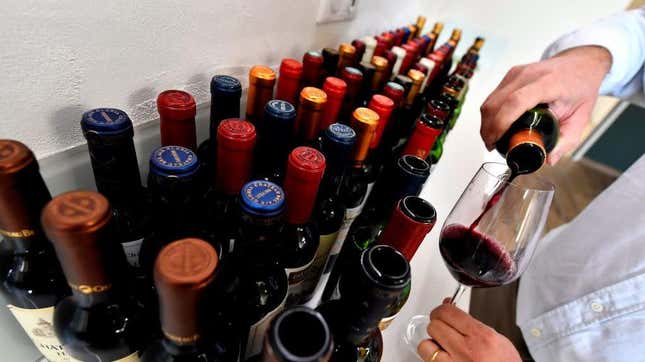 Bottles of wine lined up on white countertop